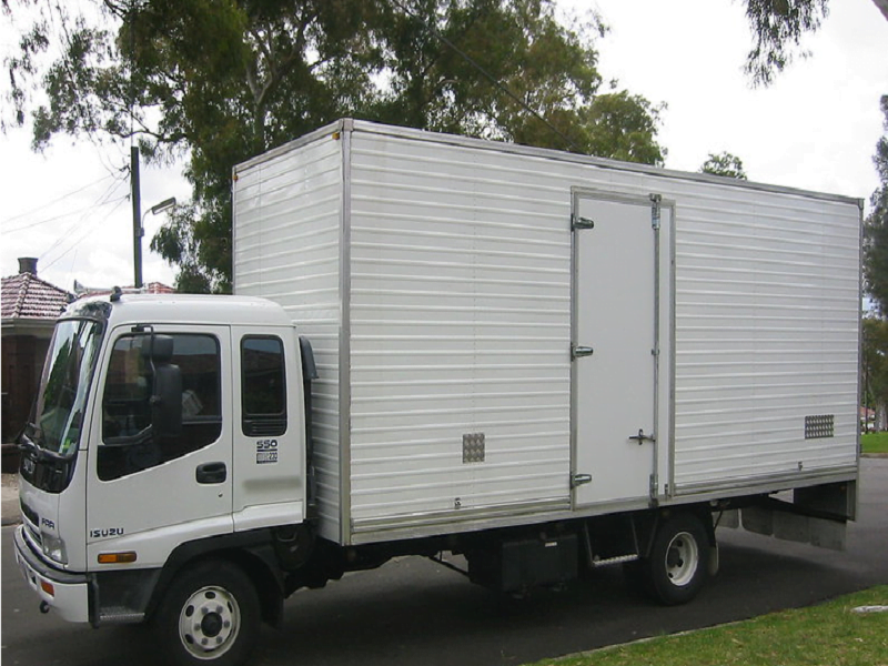 Office furniture being moved by professional removalists
